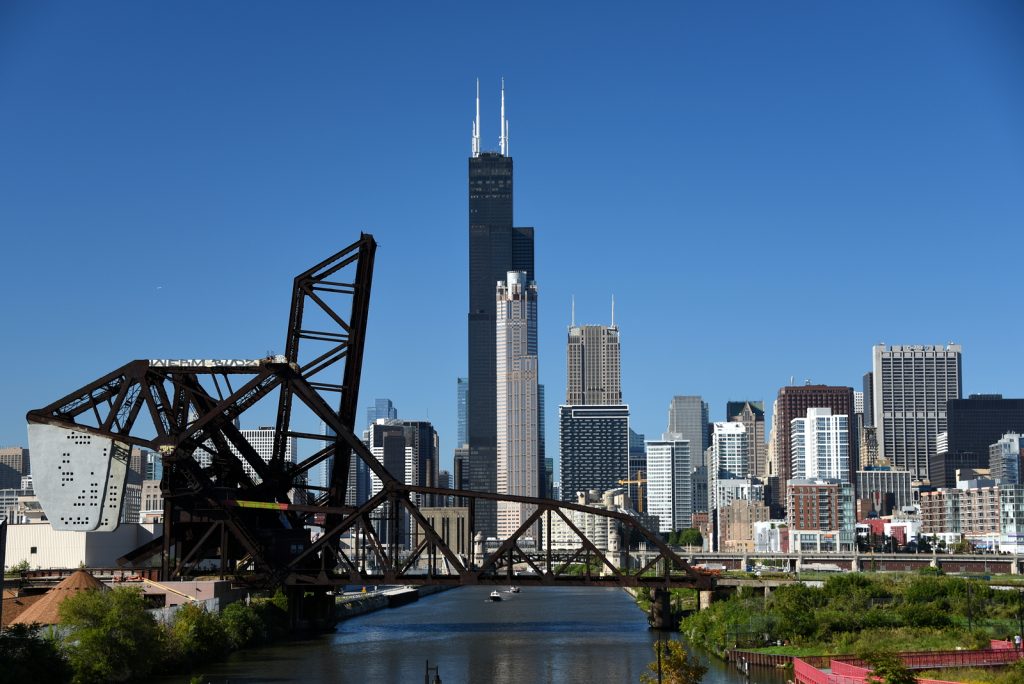 The Saint Charles bridge and Baltimore and Ohio Chicago Terminal Railroad Bridge over the Chicago River with the Willis Tower (formerly Sears Tower) and 311 South Wacker in the background under a clear blue sky, Chicago, IL September 12, 2018